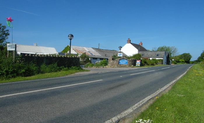 We are on the B4247and 2 miles from Scurlage on the left